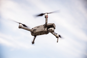 Fototapeta na wymiar Drones flying in blue sky from the bottom