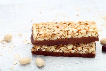 Tasty granola bars with nuts on wooden table