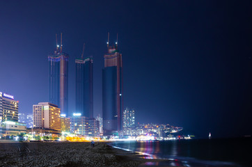 Obraz na płótnie Canvas Office blocks at Huandae in Busan, South Korea seen from the beach at night.