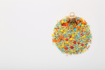 Colorful sprinkles in shape of a christmas ball on white background