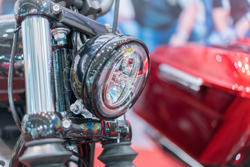 Close-up on chrome headlights of luxury Motorcycle. Chromed headlamp of a motorcycle, stylish...