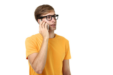 Beautiful young man talking on a mobile phone on white background