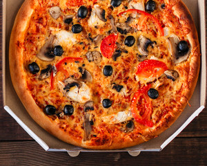 pizza, mushrooms, olives, chicken, tomato sauce, cheese, (pizza ingredients). hot pizza. Top view. copy space