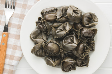 Squid ink tortellini pasta.