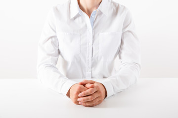 Fototapeta premium Business woman in white sitting at a desk.