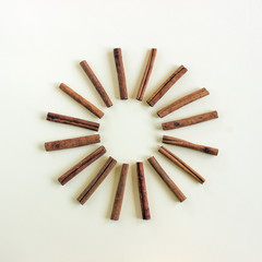 Creative and minimalist composition of cinnamon sticks in the form of a star or sun. Concept-...