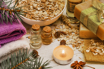 Handmade soap and cleansing oil on white rustic wooden background. Honeycomb, oats and honey. Natural organic cosmetic. SPA concept.