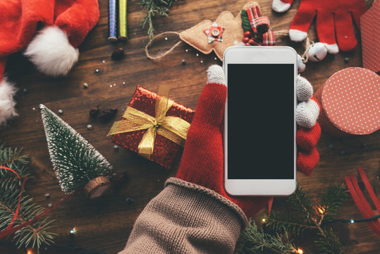 Smartphone in hand for Christmas season mock up