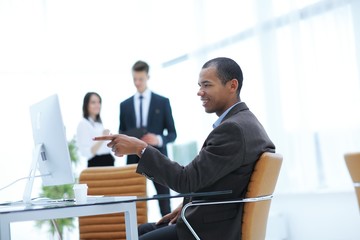successful business man ,pointing a finger at the computer screen.