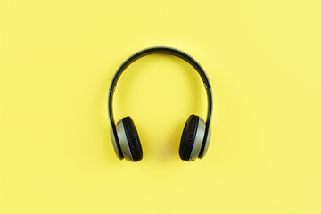 Fashionable headphones on yellow background. Music concept.