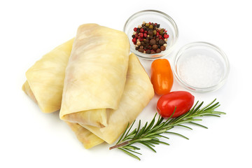 Homemade cabbage rolls with herbs and spices, isolated on a white background. Close-up