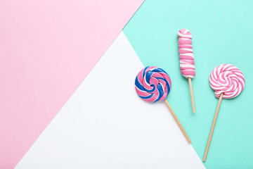 Sweet lollipops on colorful background