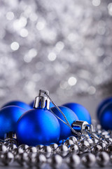 Christmas composition of Christmas tree toys on a blurred silver background