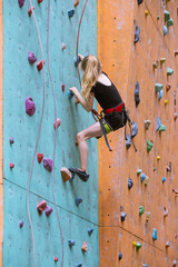 little girl climbing up the wall