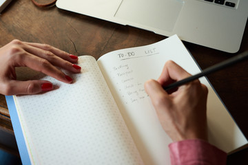 Woman writing to do list