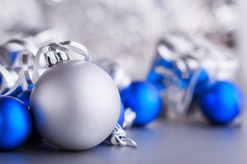 Christmas composition of Christmas tree toys on a blurred silver background