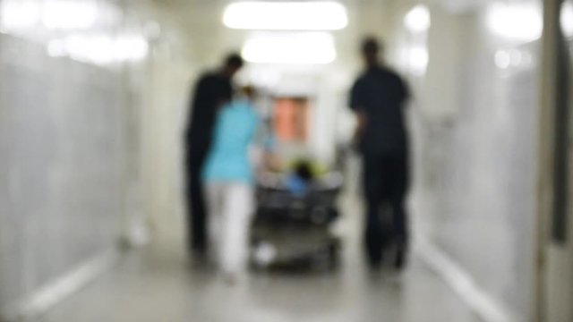 Emergency Department: Doctors, Nurses and Surgeons Move Seriously Injured Patient. Blurred video