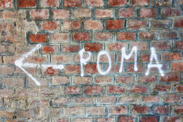 To Rome graffiti on a brick wall