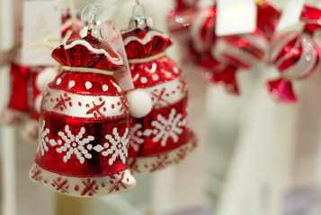 New year and christmas background. Shiny red decorations in shape of bag with ornament for christmas tree. Copy space.