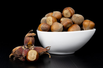 Tasty hazelnuts on a black kitchen table. Ingredients for preparing the dough in the home kitchen.
