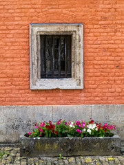 Fototapeta na wymiar Architectural detail from the Castle of Lavaux-Saint-Anne near Rochefort, Province of Namur, Belgium, a window and an old stone planter