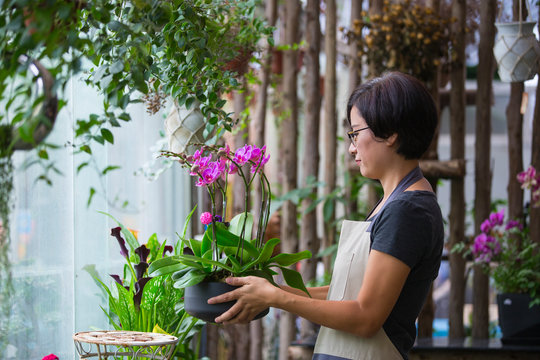 Asian female florist working in the flower shop