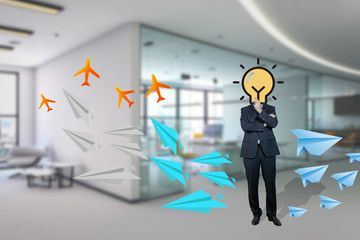 Businessman with bulb instead head standing in the office