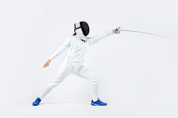 Young fencer athlete wearing mask and white fencing costume. holding the sword. Isolated on white...