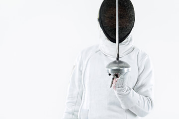 Fencer athlete wearing mask and white fencing costume and holding the sword, . Isolated on white...