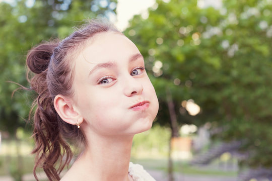 Young girl puffing out her cheeks