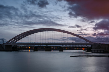 Railway bridge over Martwa Wisla river at dusk in Gdansk. Poland Europe.