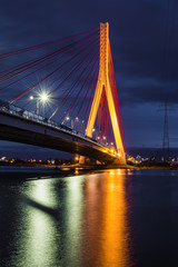 Illuminated cable stayed bridge over Martwa Wisla river at night in Gdansk. Poland Europe