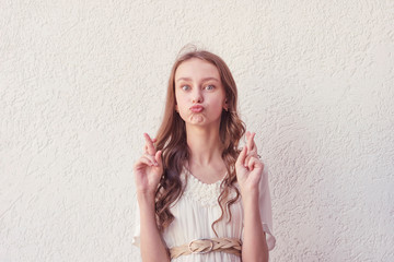 Woman hopes for good luck with fingers crossed