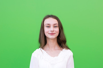 Young european female on green wall