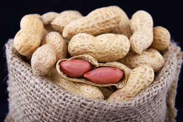 Peanuts in a peel in a bag on a black isolate.