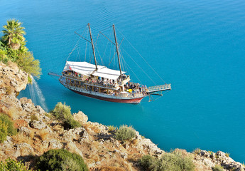 Pleasure yacht near the steep shore
