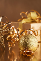 Christmas composition of Christmas tree toys on a blurred gold background