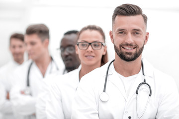 Team of smiling professional doctors standing together