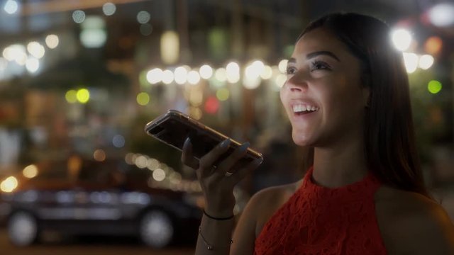 Young Beautiful Sends a Voice Message Using Her Smartphone