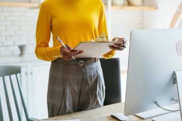 Anonymous businesswoman working in a modern office. 