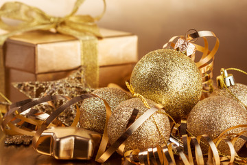 Christmas composition of Christmas tree toys on a blurred gold background