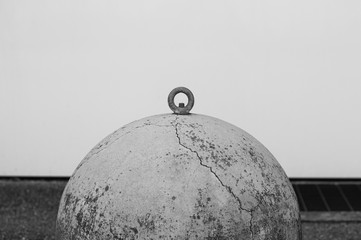 Isolated ruined traffic bollard - Concrete element on the asphalt (Pesaro, Italy, Europe)