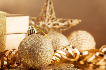 Christmas composition of Christmas tree toys on a blurred gold background