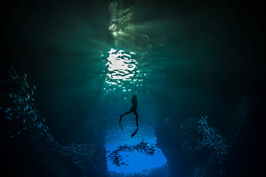 A female free diver divng in the cavern