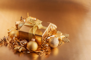 Christmas composition of Christmas tree toys on a blurred gold background