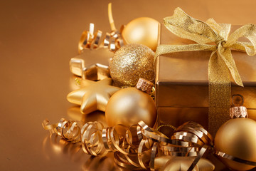 Christmas composition of Christmas tree toys on a blurred gold background