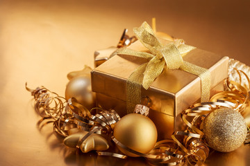 Christmas composition of Christmas tree toys on a blurred gold background