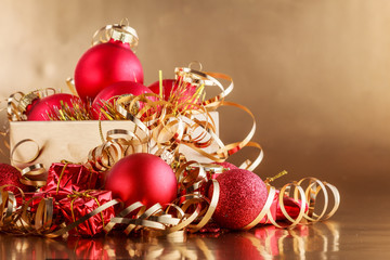 Christmas composition of Christmas tree toys on a blurred gold background