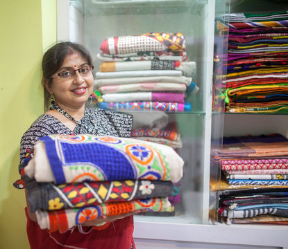 A Businesswoman who sells traditional Indian dress in a small shop