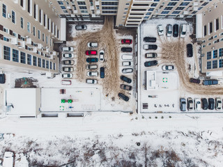 Snow covered city town and village houses in daylight with fresh snow and covered roofs.